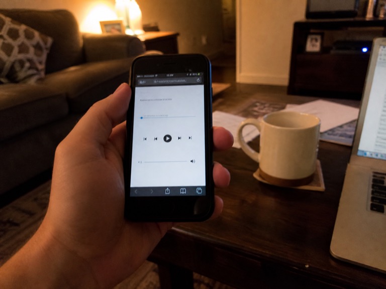 Phone in the browser showing an audio player with playback controls